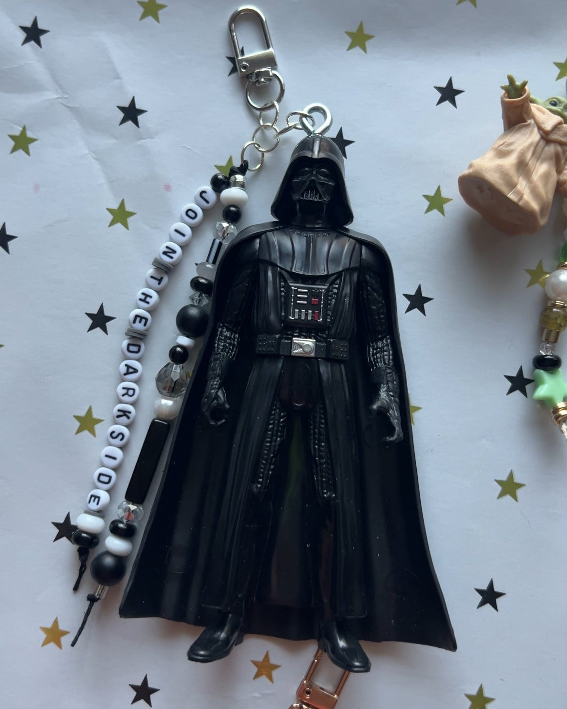 Darth Vader keychain with beads on a star-patterned background