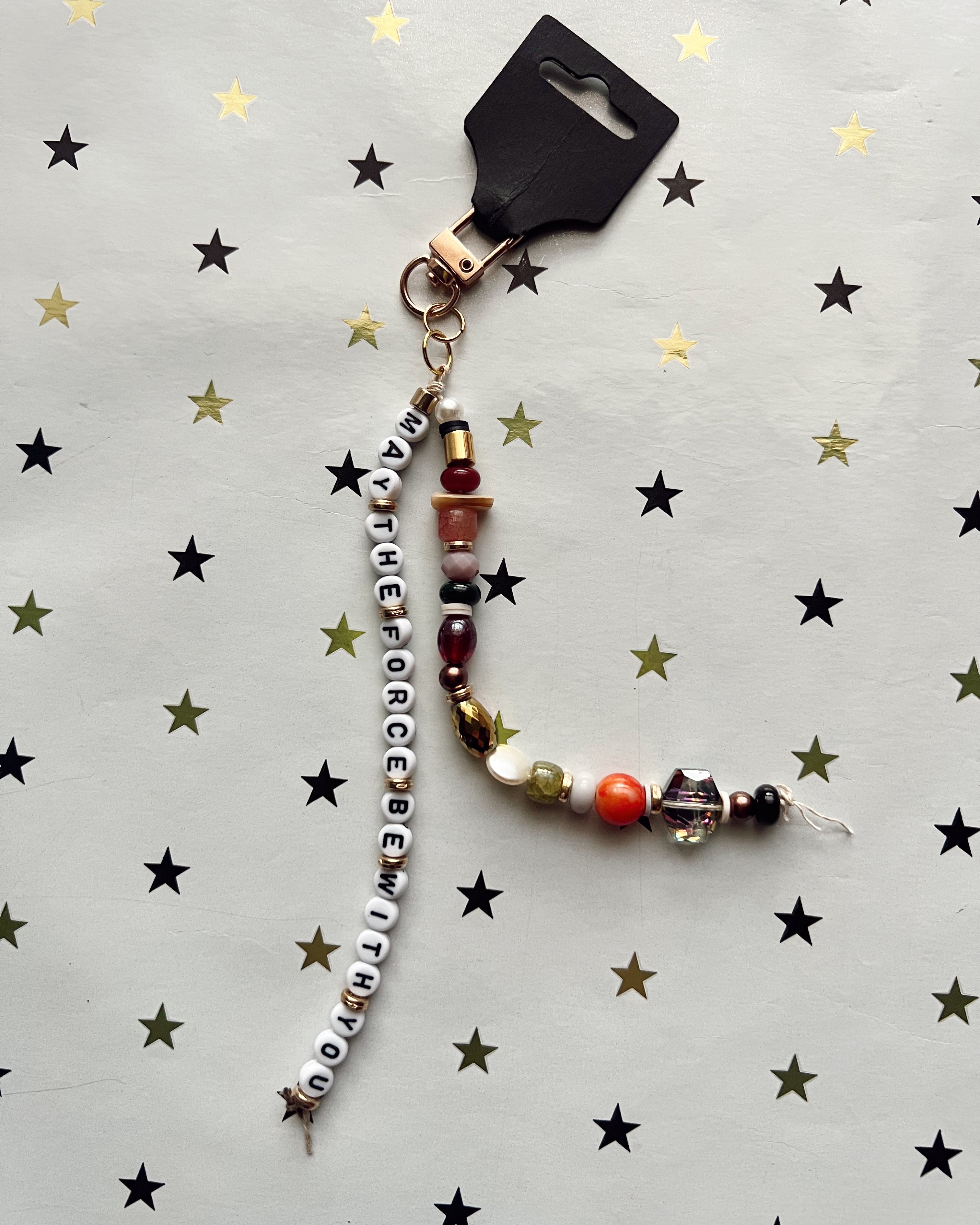 Beaded keychain with 'May the Force Be With You' on a star-patterned background
