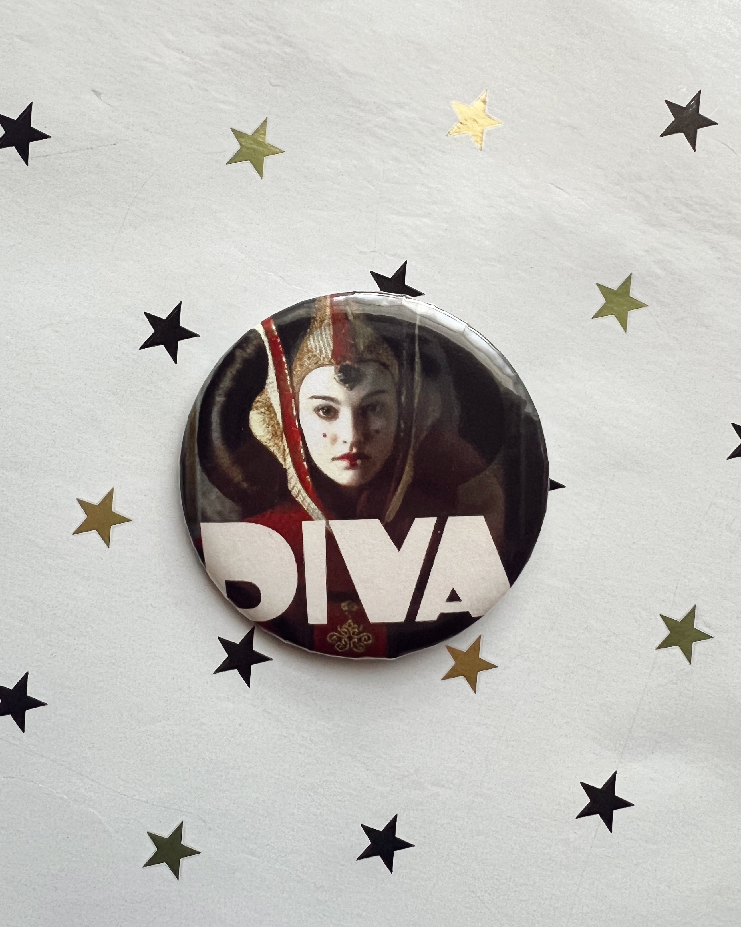 Button badge with a portrait and 'DIVA' text on a star-patterned background