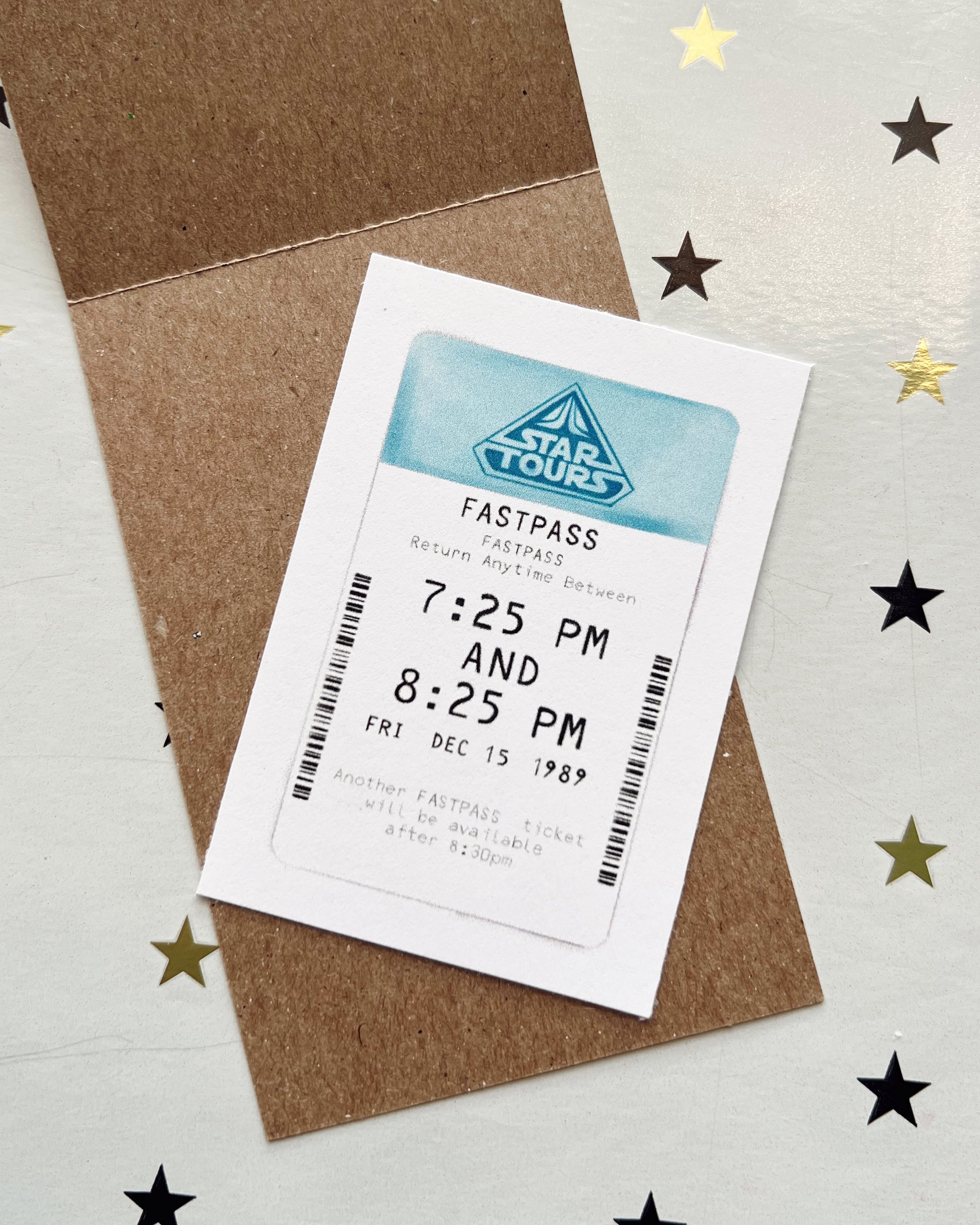 Event ticket with FastPass+ on a brown envelope against a star-patterned background